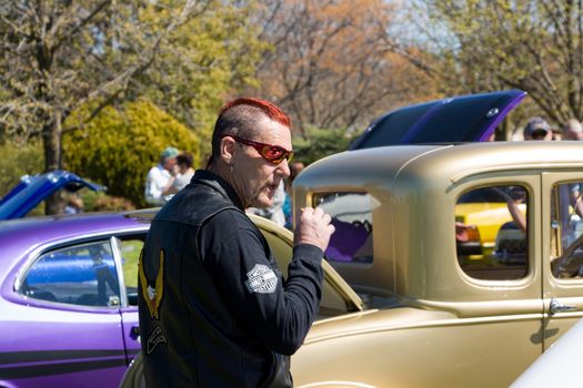 VICTORIA/AUSTRALIA - SEPTEMBER 2015: Motorcycle rider smoking. Taken at a classic car show on the 13th September 2015 in Corowa, Australia.