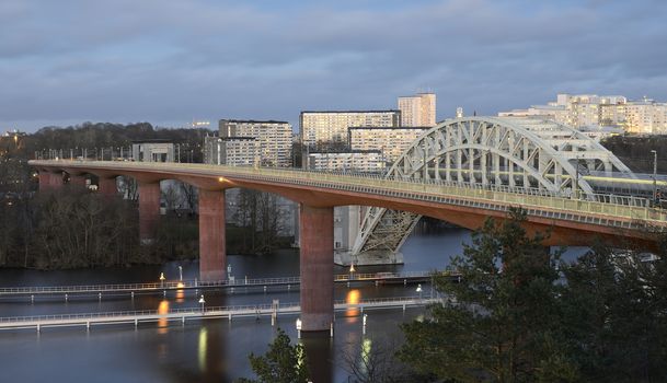 Night view of Southern part of Stockholm with railway bridge in the foreground.