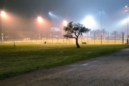 Empty soccer field at night.