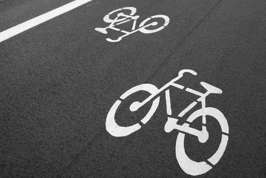 Bike lane. Sign for bicycle painted on the asphalt.