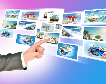 Businessmans finger touching holographic pictures on abstract background