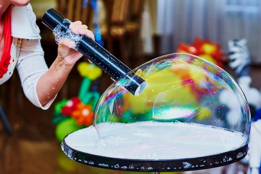 Big soap bubble on a children's holiday                               