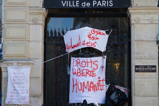 FRANCE, Paris: Several signs claming for liberty and human rights cover the front of the city hall of the 18th arrondissement in Paris, on September, 15, 2015. Almost hundred and fifty refugees from South Soudan and Eritrea camp in front of the city hall of the 18th arrondissement in Paris since September, 4, 2015. Paris mayor Anne Hidalgo announced on September, 15, 2015 giving them a place in one of the seven installations opened in the capital and around las week. 
