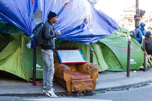 FRANCE, Paris: One refugee stand in front of the city hall of the 18th arrondissement in Paris, on September, 15, 2015. Almost hundred and fifty refugees from South Soudan and Eritrea camp in front of the city hall of the 18th arrondissement in Paris since September, 4, 2015. Paris mayor Anne Hidalgo announced on September, 15, 2015 giving them a place in one of the seven installations opened in the capital and around las week. 