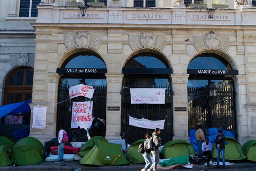 FRANCE, Paris: Several signs claming for liberty and human rights cover the front of the city hall of the 18th arrondissement in Paris, on September, 15, 2015. Almost hundred and fifty refugees from South Soudan and Eritrea camp in front of the city hall of the 18th arrondissement in Paris since September, 4, 2015. Paris mayor Anne Hidalgo announced on September, 15, 2015 giving them a place in one of the seven installations opened in the capital and around las week. 