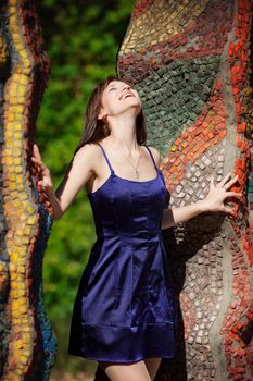 beautiful girl in a blue dress in the summer park