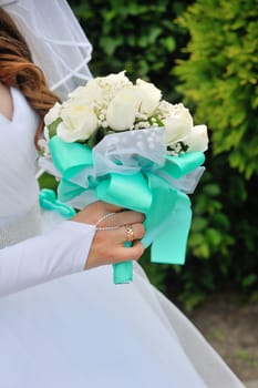Bride Holding Bouquet of White Roses