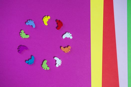 colored sheets of paper, handmade, footprints in a circle