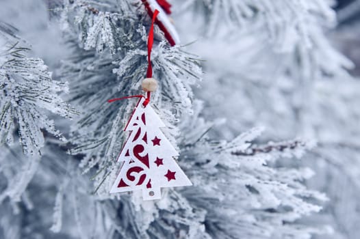 Christmas background with snow-covered Christmas tree and Christmas toy