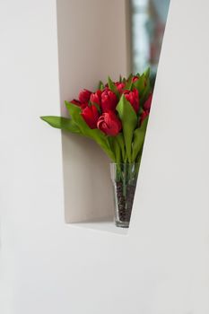 bouquet of red tulips on the windowsill