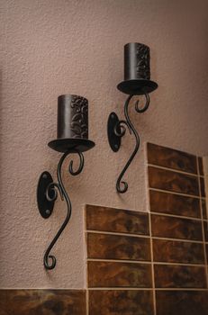 Candlesticks with candles on the wall in the room