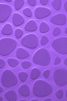 Background of Purple Droplet Shaped Stone on Cement Wall closeup