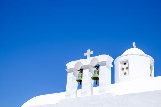 Detail view of bells and roof of traditional Greek cycladic church, Plaka village, Greece