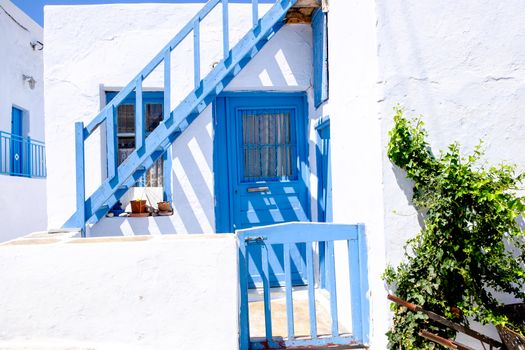 Typical traditional doors and windows in white and blue style, Plaka village on Milos island, Greece