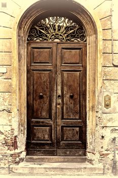 Wooden Ancient Italian Door in Historic Center, Retro Image Filtered Style