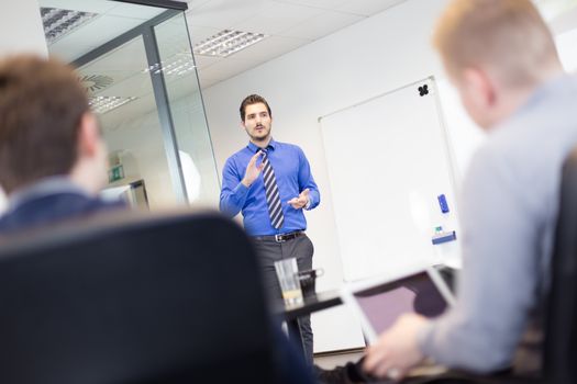 Workplace in modern office with business people brainstorming. Businessman working on laptop during the meeting.