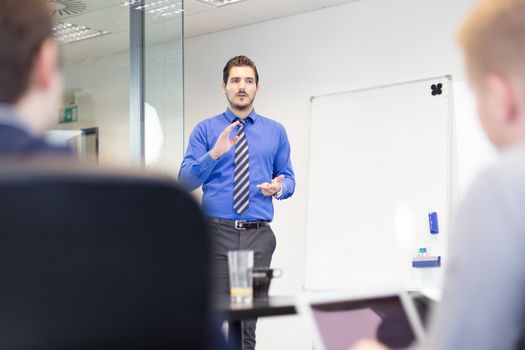 Workplace in modern office with business people brainstorming. Businessman working on laptop during the meeting.