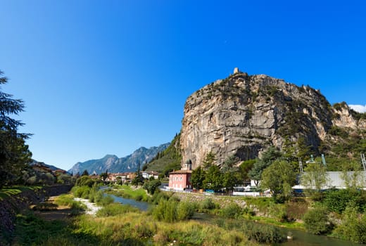 Rock walls with castle in Arco of Trento and Sarca river near the Garda Lake in Trentino Alto Adige, Italy, Europe