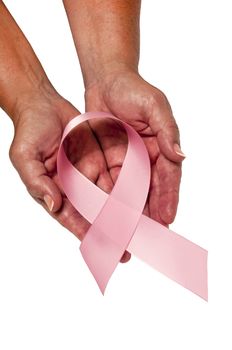 Vertical shot of a pair of gentle female hands holding a large pink breast cancer awareness ribbon