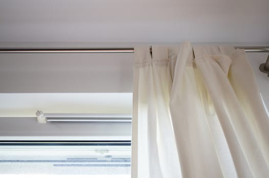 Light fabric curtains by an window