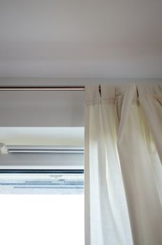 Light fabric curtains by an window
