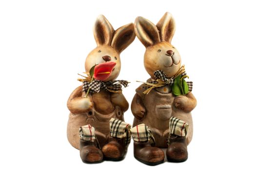 Two enamored rabbit - ceramic toy souvenirs on white background