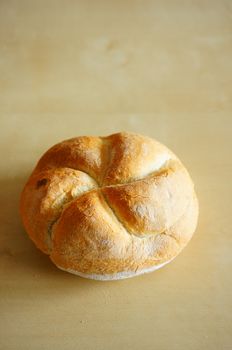 Whole bread on wooden background