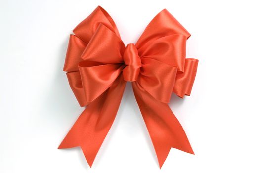 Close up shot of a brightly colored orange bow.  On white background