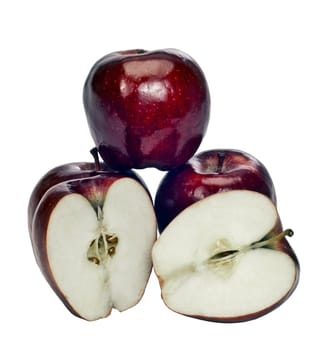 Cute vertical shot of delicious juicy red apples sliced open to show the inside and whole to show the outside.  On white background