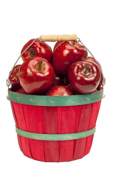 Vertical shot of a cute little red basket full of delicious red apples on a white background.