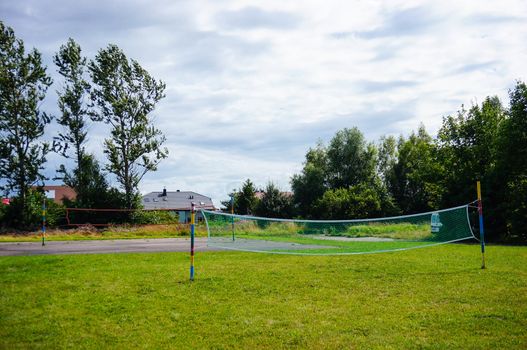 Volleyball net on green grass