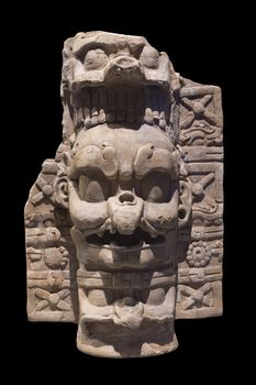 Frightening depiction of K'awiil, the Lightning God, on a ceramic Mayan incense burner base isolated on black background