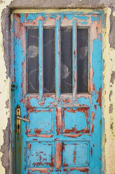 Old rusty wooden colorful door with textured structure