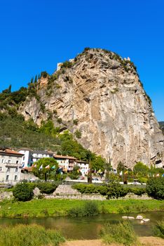Rock walls with castle in Arco of Trento and Sarca river near the Garda Lake in Trentino Alto Adige, Italy, Europe