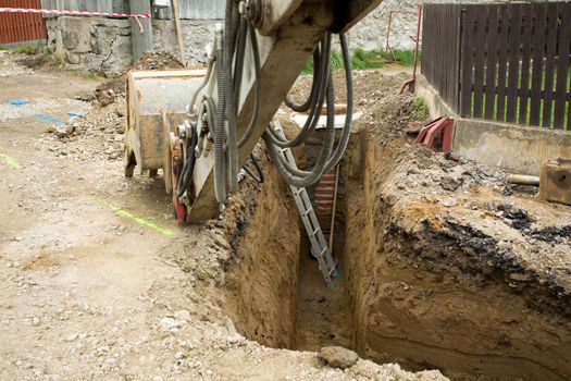 excavator ploughshare on trench - constructing canalization in european project - wastewater treatment plant, ecology project