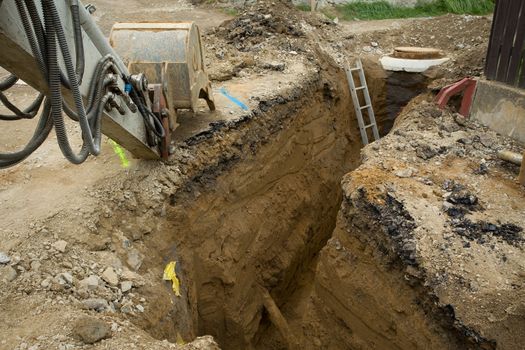 excavator ploughshare on trench - constructing canalization in european project - wastewater treatment plant, ecology project