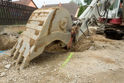 excavator ploughshare on trench - constructing canalization in european project - wastewater treatment plant, ecology project