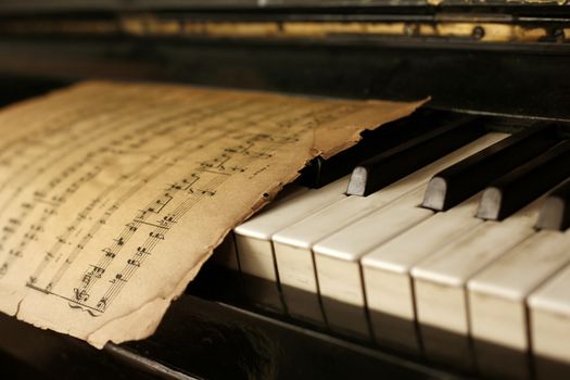 The keyboard of the piano and old notes