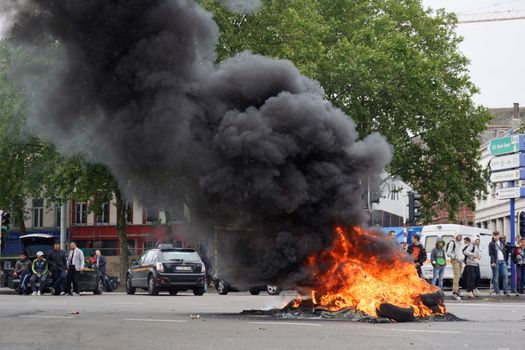 BELGIUM, Brussels: A tire is burning in a street of Brussels, Belgium, as hundreds of European taxi drivers protest against taxi-app Uber, on September 16, 2015. The international convoy of around 300 taxis with horns beeping crawled into the city's busy European quarter in hopes of meeting Belgian and EU officials, bringing traffic on main roads to a standstill.
