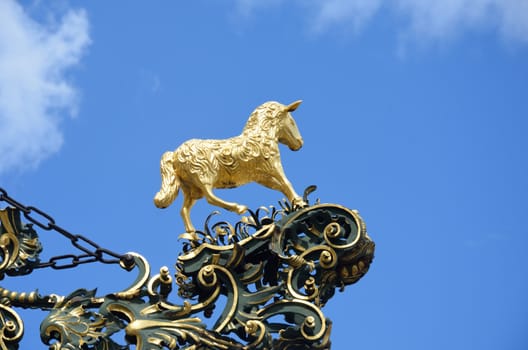 Golden sheep sculpture  on sign