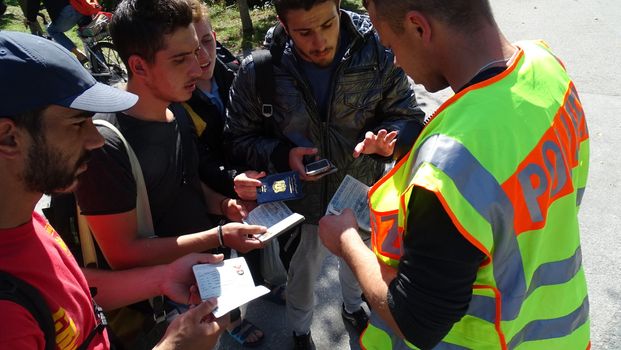 GERMANY, Freilassing: Refugees interact with German police at the gates of Freilassing, Bavaria, on the German side of the Germany-Austria border, September 16, 2015.
