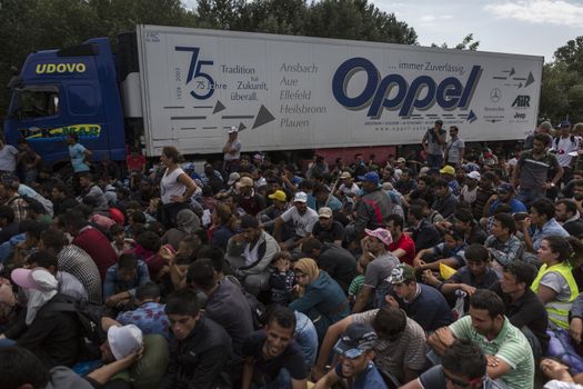 SERBIA, Horgos: Refugees wait at the Serbia-Hungary border, blocking traffic, after Hungary closed the border crossing on September 16, 2015.****Restriction: Photo is not to be sold in Russia or Asia****