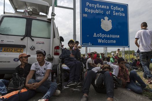 SERBIA, Horgos: Refugees wait at the Serbia-Hungary border, blocking traffic, after Hungary closed the border crossing on September 16, 2015.****Restriction: Photo is not to be sold in Russia or Asia****
