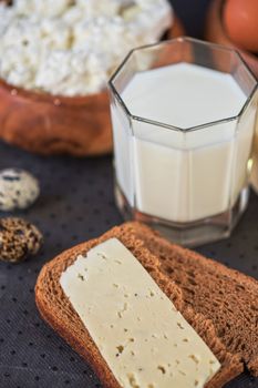 still life with dairy products as milk, cheese cottage cheese eggs and bread 