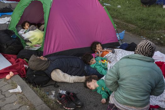 SERBIA, Horgos: Refugees wait at the Serbia-Hungary border, blocking traffic, after Hungary closed the border crossing on September 16, 2015.****Restriction: Photo is not to be sold in Russia or Asia****