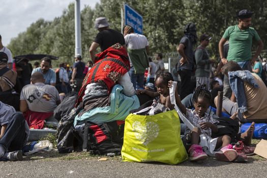 SERBIA, Horgos: Refugees lie and wait at the Serbia-Hungary border, blocking traffic, after Hungary closed the border crossing on September 16, 2015.****Restriction: Photo is not to be sold in Russia or Asia****