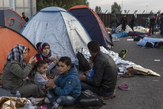 SERBIA, Horgos: Refugees wait at the Serbia-Hungary border, blocking traffic, after Hungary closed the border crossing on September 16, 2015.****Restriction: Photo is not to be sold in Russia or Asia****