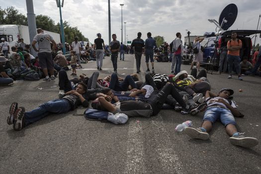 SERBIA, Horgos: Refugees lie and wait at the Serbia-Hungary border, blocking traffic, after Hungary closed the border crossing on September 16, 2015.****Restriction: Photo is not to be sold in Russia or Asia****