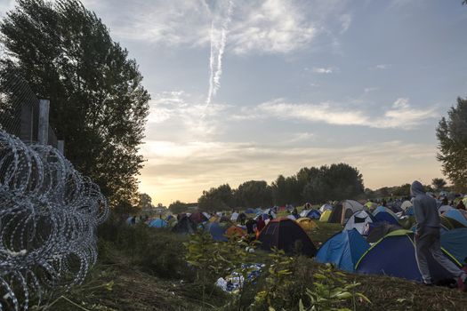 SERBIA, Horgos: A makeshift refugee camp at the Serbia-Hungary border sits by razor barbed wire, after Hungary closed the border crossing on September 16, 2015.****Restriction: Photo is not to be sold in Russia or Asia****