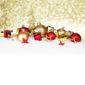 Red and golden christmas balls and decoration on snow